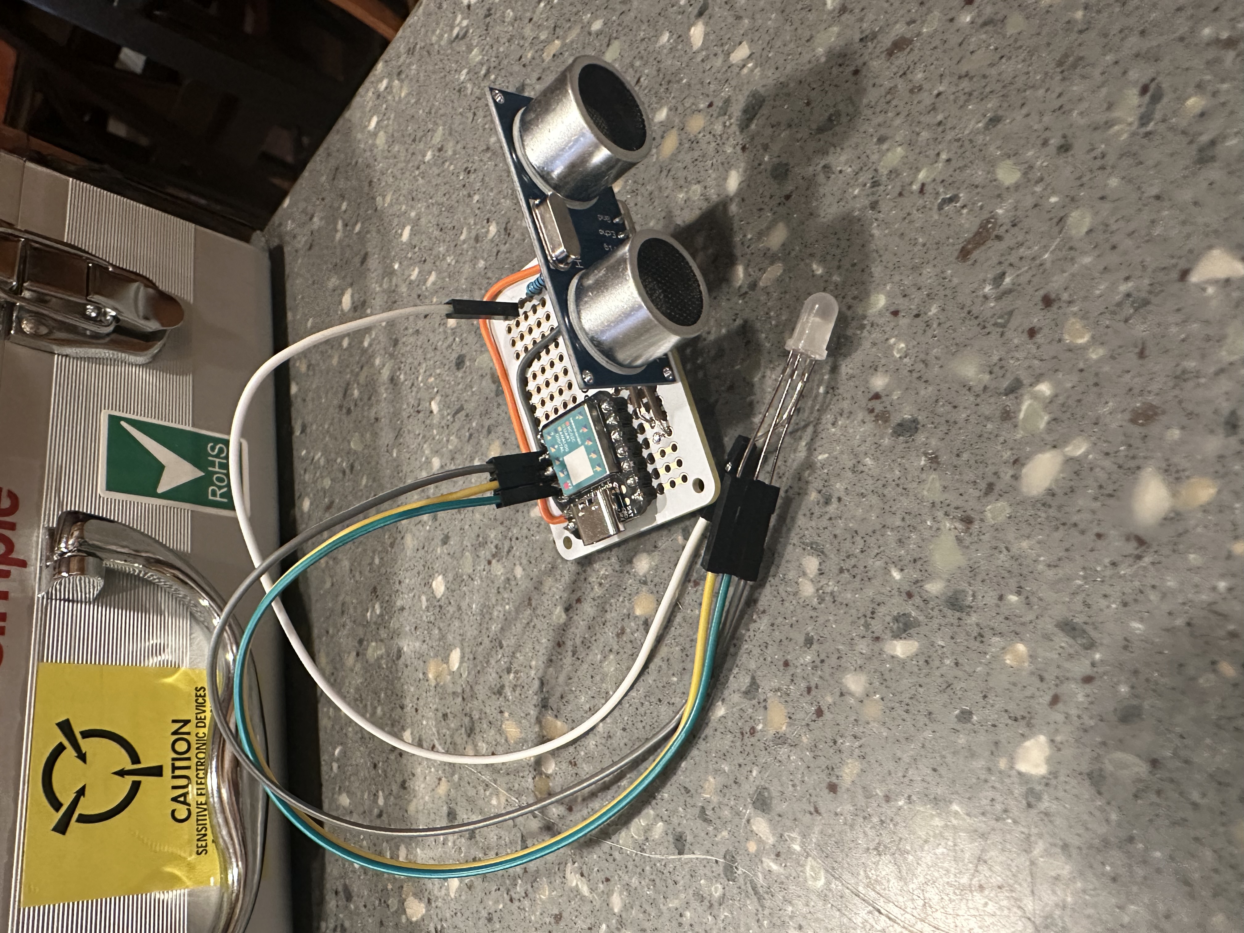 Ultrasonic sensor project built on a small breadboard with LED output