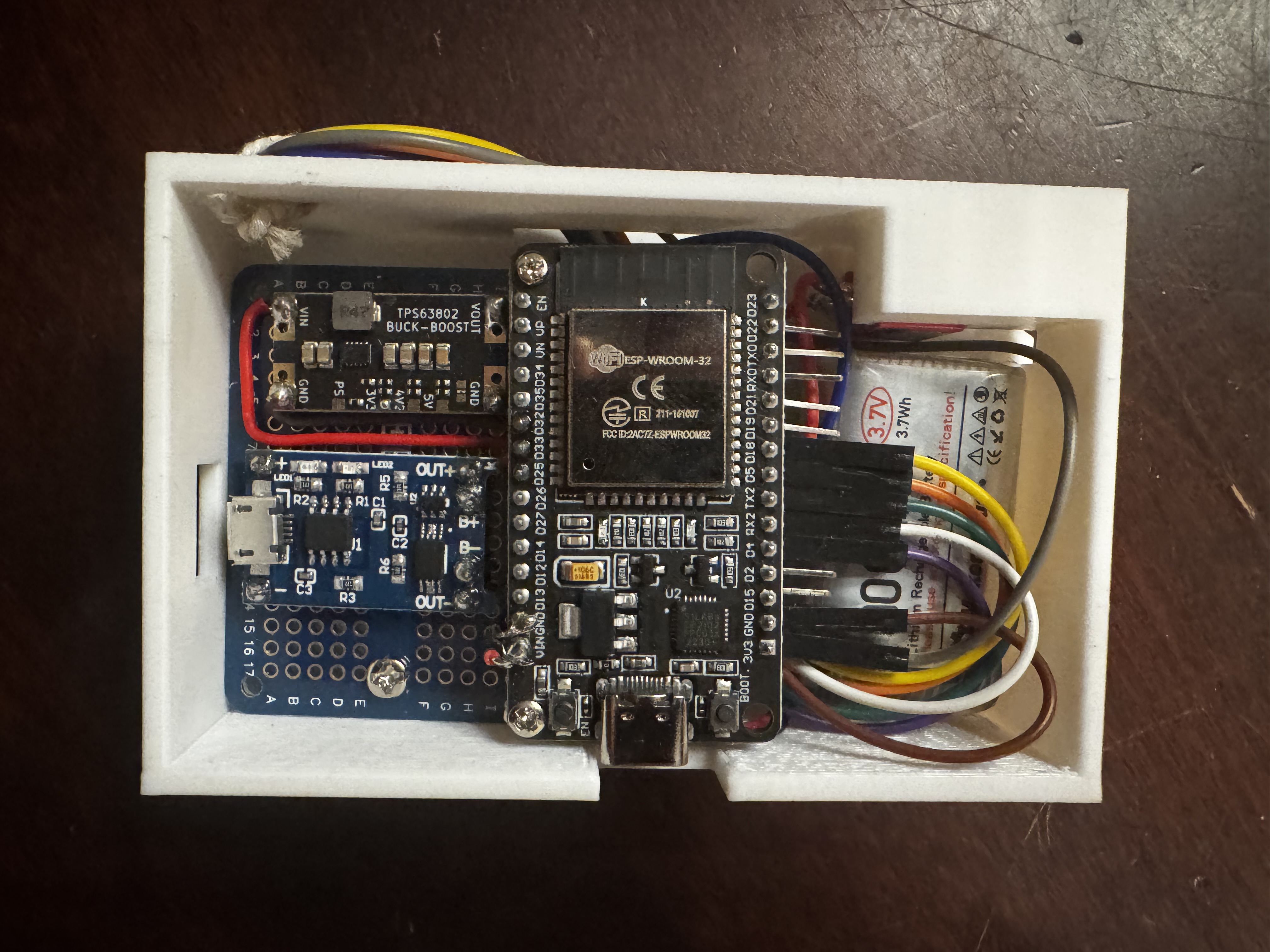 Main internal view of the ESP32 ornament showing the ESP32, charging module, buck-boost converter, and battery