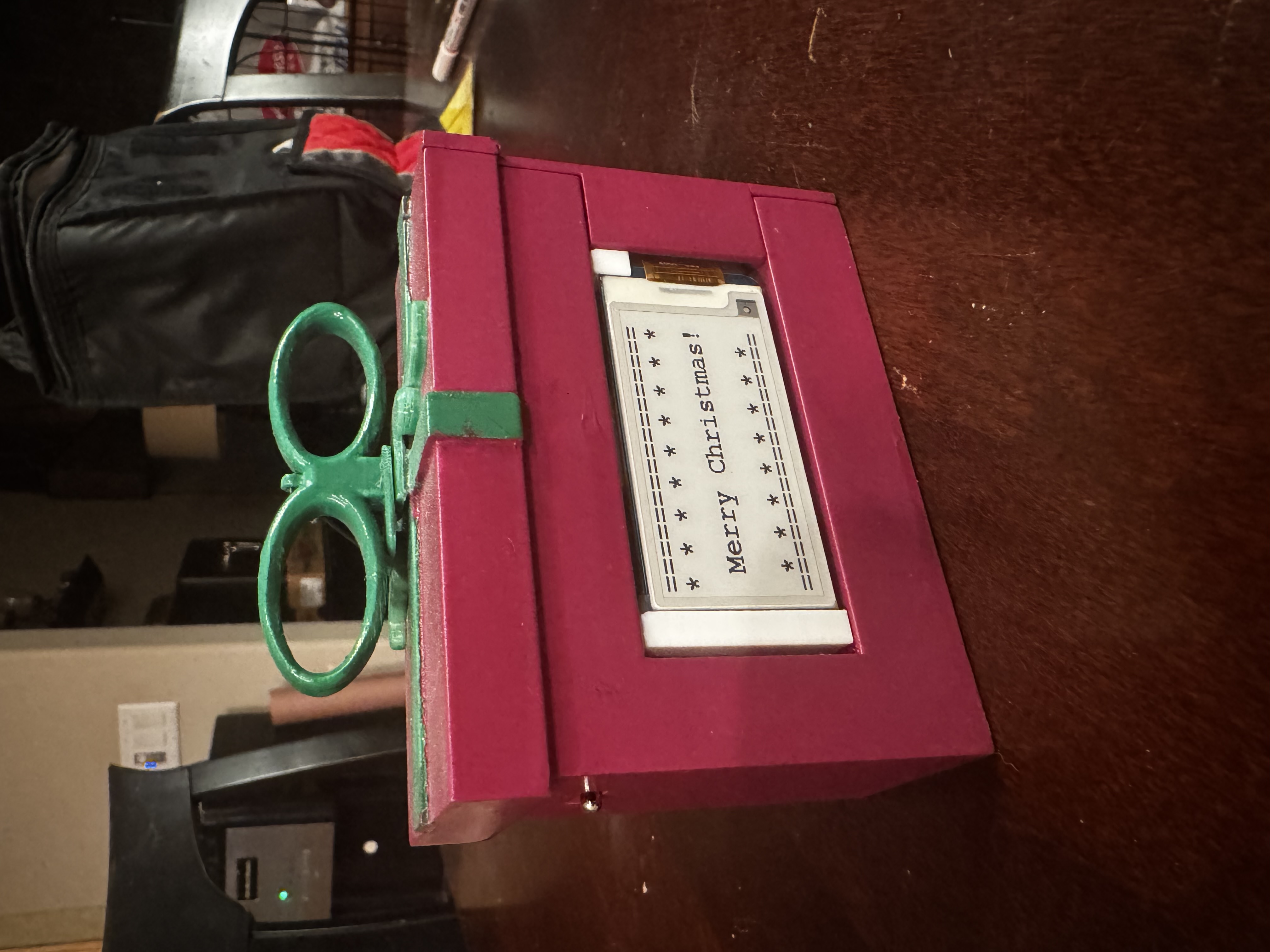 Front view of the completed ornament showing the e-ink display message