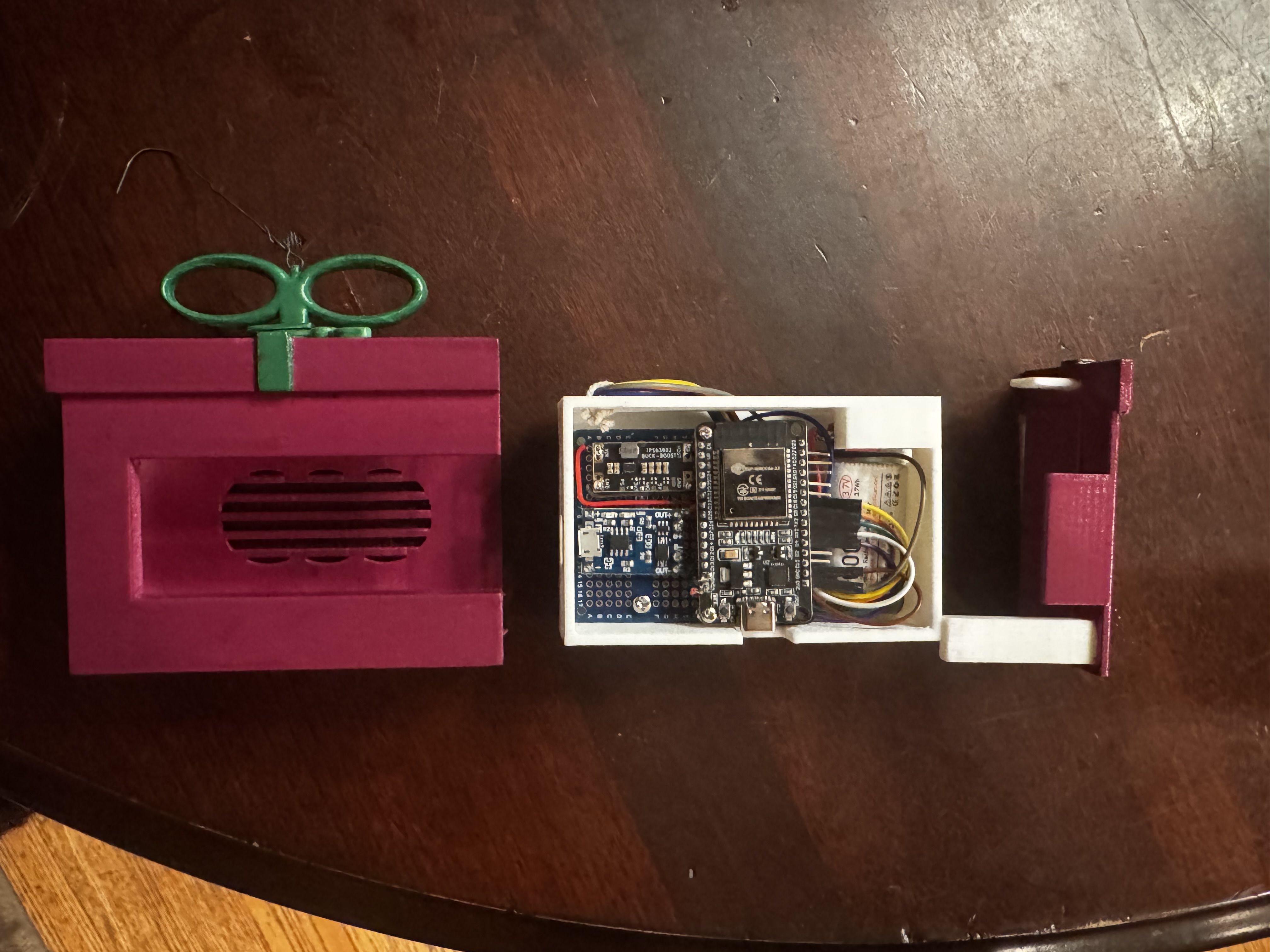 Exploded view of the ESP32 ornament showing the enclosure parts and internal electronics